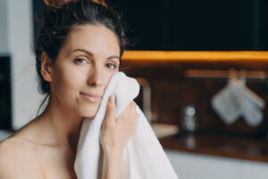 A woman cleans her face after a treatment with the Best Skin Care Products in Denver